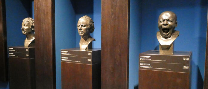 three busts one of yawning man