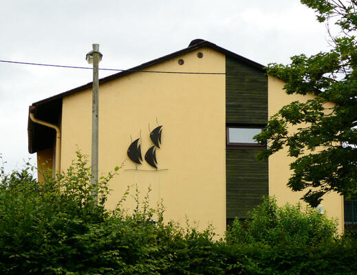house with metal fish on side