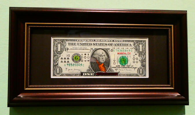 defaced dollar bill