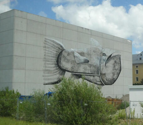 large fish painted on wall of building