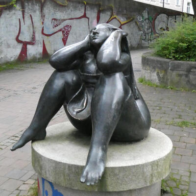 sculpture of seated naked lady