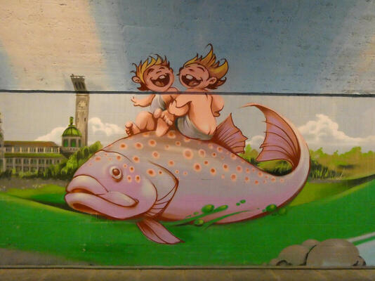 Two laughing children on back of a large fish