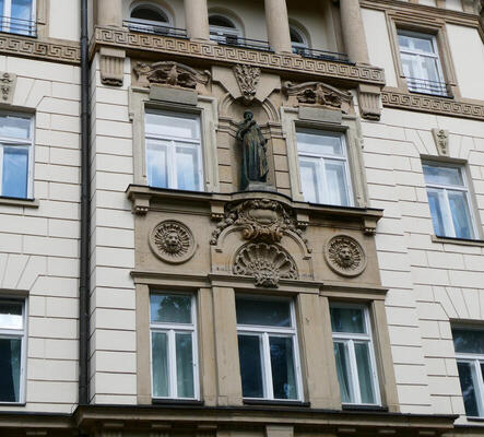 building with statue between windows