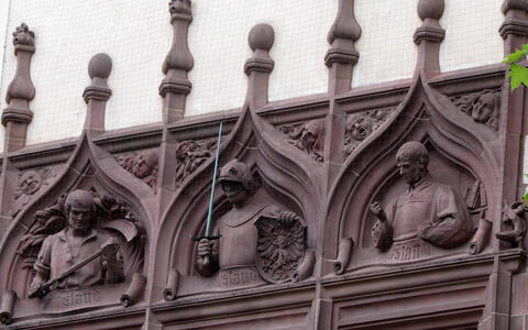 relief figures on old building