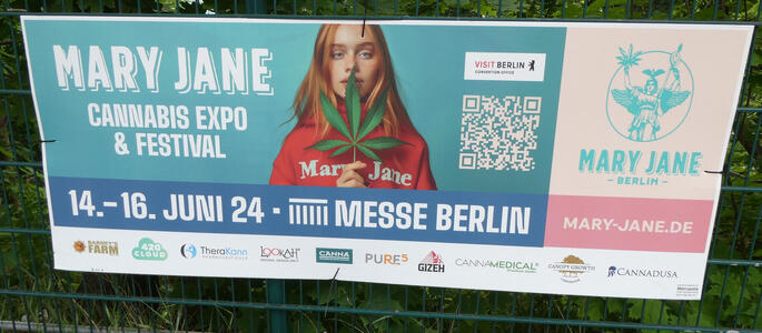 Mary Jane Cannabis Expo & Festival, 14-16 June. Woman wearing red hoodie labeled Mary Jane.