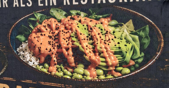 AI slop advertisement for a restaurant showing a dish that appears to have meat, rice, and green vegetables covered in a brown gravy.