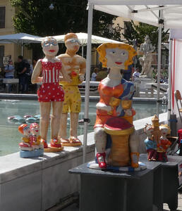 Cartoonish ceramic sculptures of people in bathing suits.