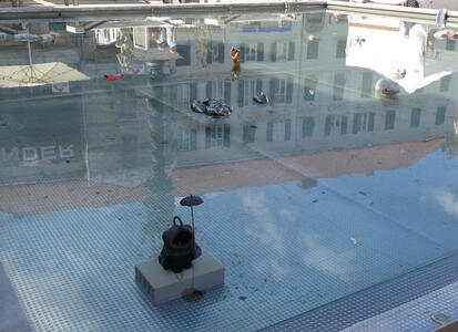 Shallow pool with small ceramic sculptures scattered throughout.