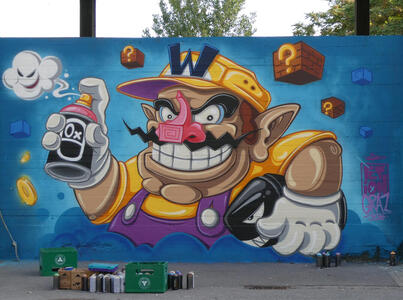 Wario holding a spray paint can in one hand and a shark-like object in the other.