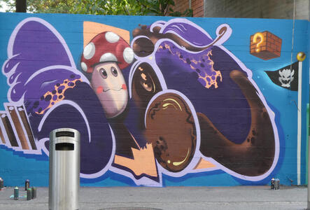 Wall panel with abstract wave and a mushroom-shaped game character