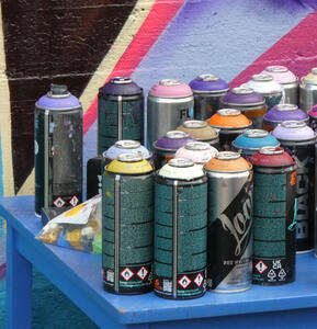 Array of spray paint cans in various colours