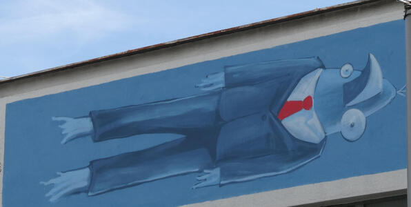 Bird in a blue suit with red tie