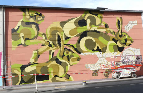 Nearly-completed artwork of rabbits in camouflage-like colours