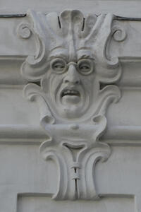 Man with glasses, looking to side, with a disgusted/angry look on his face