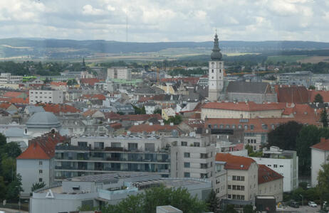 view of city; at center right is a tall church spire.