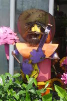 Metal sculpture of man with guitar and cowboy hat