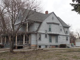 Weathered gray wooden three-story house