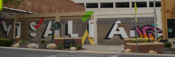 Mural of city name Visalia with colored shapes among the letters