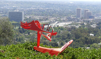 Abstract orange sculpture with “wings”