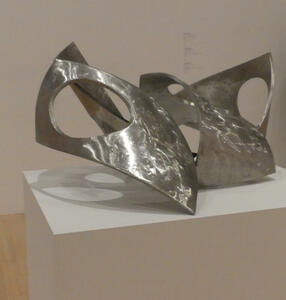 Aluminum sculpture reminiscent of a mobius strip