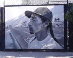 Black and white art; man with goatee and ponytail, wearing baseball cap, in profile.