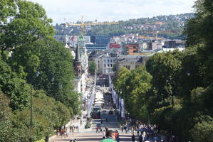 Steep road in center, city in background