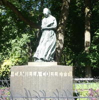 Statue of woman, head bent, arms folded