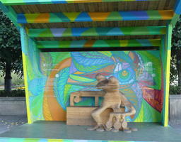 Wooden bench with wooden sculpture of amazon tree frog