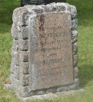 Weathered headstone with grooves around edges