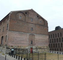 old brick building with arches that have been filled in with bricks