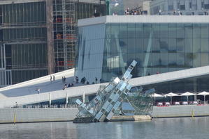 Abstract steel sculpture in water outside opera house