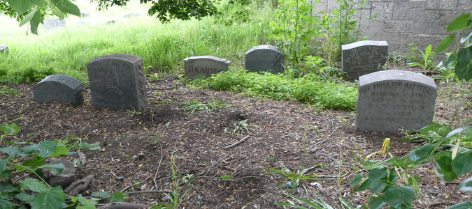 Group of six small headstones (about 30cm tall)