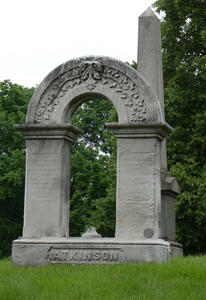 Large arch in foreground; obelisk in background