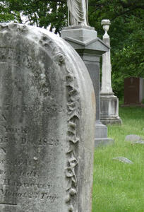 Detail of weathered carving on side of headstone