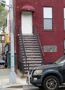 Narrow, steep 15-step staircase to front door of a house