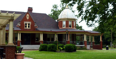 Red brick building with dome on one side.