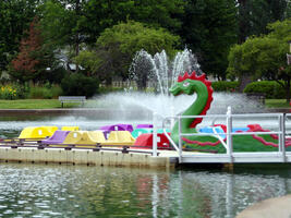 Colorful paddle boats, plus one in shape of green dragon