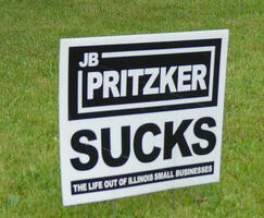 Lawn sign: J B Pritzer Sucks (and in small type) the life out of small businesses