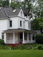 White two-story house with attached cupola