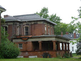 Red brick house in state of disrepair