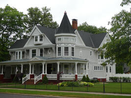 Three-story large wood house painted gray