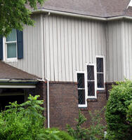 Side of house with three adjacent windows at “stepped” levels