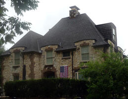 Stone house with steeply-angled A-shape roof