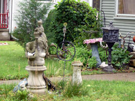 Variety of sculptures in front lawn of house