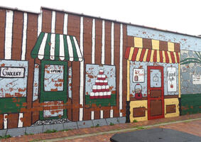 Mural of grocery and candy store on side of building