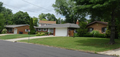 Several one-story houses in 1960s style architecture