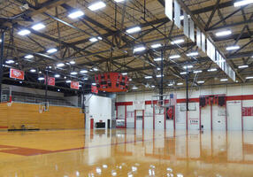 Interior of gym showing floor and basketball hoops