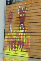 Painted area of bleachers: dragon breathing fire, balancing basketball on wing. Words: Fire pit