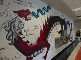 Painting of dragon on wall, accompanied by many math equations