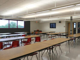 Set of long tables in a large open classroom area